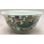A Chinese Doucai porcelain tea bowl Decorated with a pair of phoenix amongst scrolling blossom,