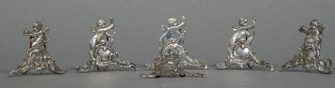 Six 19th century Continental 800 silver menu holders Each formed as a cherub on a scroll cast base.