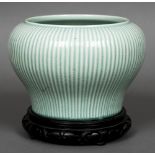 A Chinese porcelain baluster vase on stand Of ribbed form with allover celadon glazed.