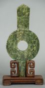 A Chinese jade bi disk Of unusual lugged form decorated with dragons chasing a pearl,