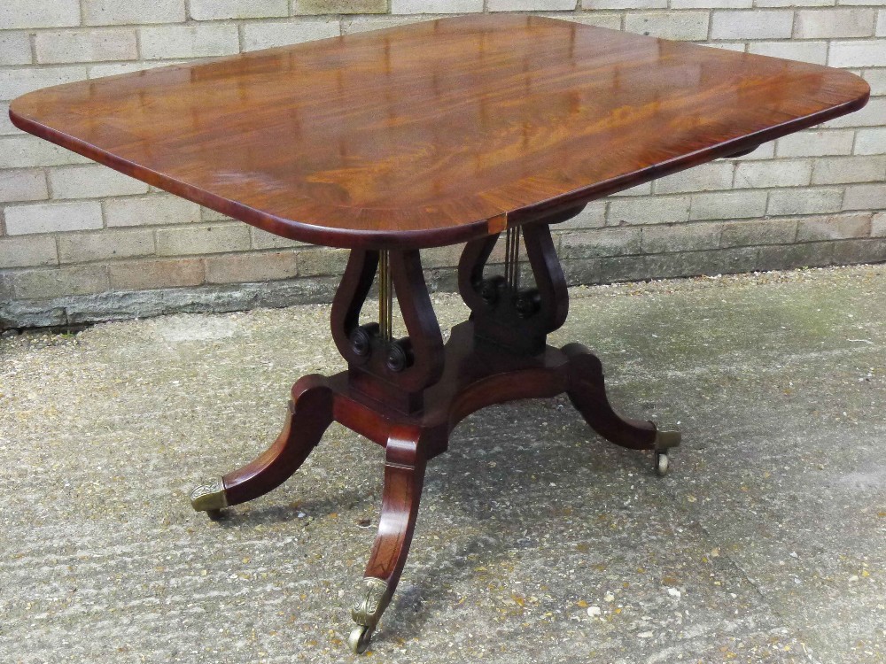 A 19th century mahogany tilt top breakfast table The crossbanded rounded rectangular top above twin