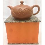 A Chinese Yixing pottery teapot and cover The body with scrolled decoration,