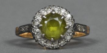 An 18 ct gold diamond and peridot flowerhead ring CONDITION REPORTS: Some general