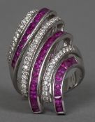 An unmarked white gold diamond and ruby set cocktail ring Of modernist design.