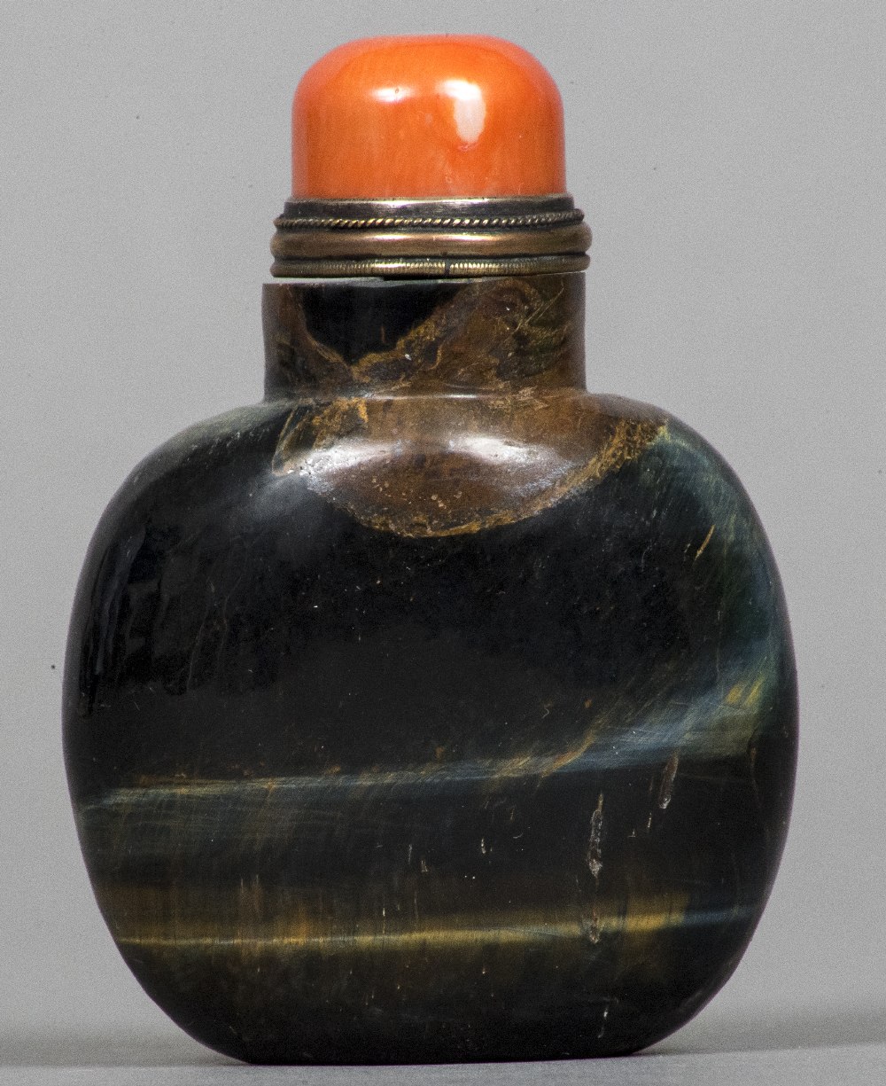 A Chinese carved mineral and red coral mounted snuff bottle and stopper 8 cm high.