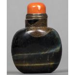 A Chinese carved mineral and red coral mounted snuff bottle and stopper 8 cm high.