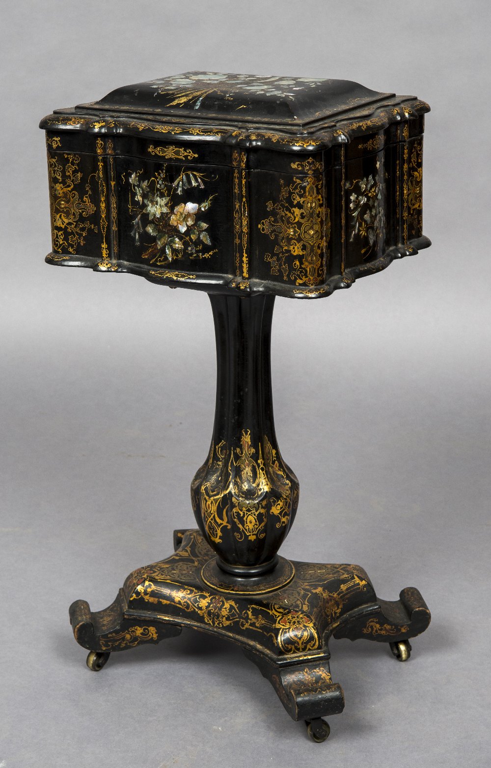 A Victorian mother-of-pearl inlaid papier mache pedestal cased decanter stand The hinged shaped top