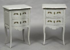 A pair of white painted bedside drawers Each with serpentine top above two drawers with brass