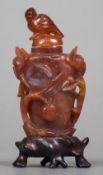 A Chinese carved red agate snuff bottle Carved with scrolling foliage,