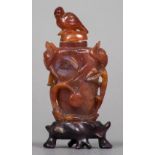 A Chinese carved red agate snuff bottle Carved with scrolling foliage,