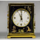 A LeCoultre Marina Black Lucite Atmos clock With gilt metal frame and Lucite front, top and side,