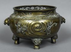 A Chinese bronze censor The flared pierced top rim above twin beast mask handles,