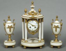 A 19th century gilt metal mounted white marble triple clock garniture The white painted dial with