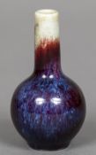 A small Chinese flambe glazed vase The elongated neck above the ovoid body,