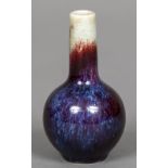 A small Chinese flambe glazed vase The elongated neck above the ovoid body,