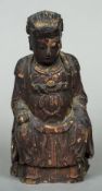 An antique Chinese painted wooden temple figure Modelled seated in flowing robes with iron red and