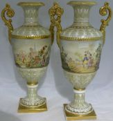 A pair of Continental porcelain twin handled vases Each decorated with Oriental figures in a