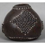 A Congolese drum Formed from a gourd with applied cowrie shell and seed pod decoration. 41 cm high.