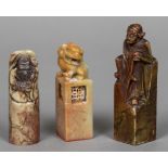 Three Chinese carved soapstone seals Two figurally carved, the other carved with a dog-of-fo.