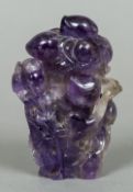 A Chinese carved amethyst vase and cover Carved with Guanyin before a flowering bush. 12 cm high.