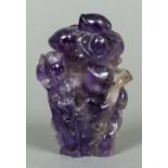 A Chinese carved amethyst vase and cover Carved with Guanyin before a flowering bush. 12 cm high.