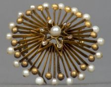 An unmarked gold diamond and seed pearl set pendant/brooch, possibly Russian Of starburst form. 3.