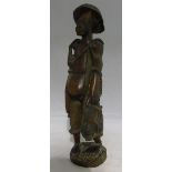 An African "tribal" carved hardwood figure of a fisherman holding his catch 48 cm high.