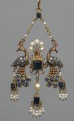 A gem set unmarked gold pendant Formed as two peacocks,