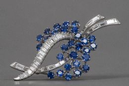 A platinum, diamond and sapphire set brooch Of floral spray form. 5.25 cm wide.