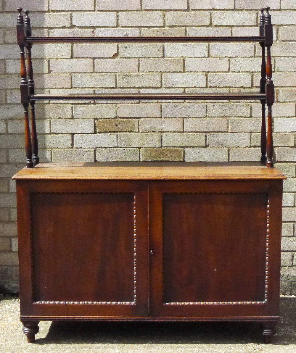 A 19th century mahogany bookcase The two upper tiers supported on turned uprights above the