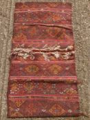 A Caucasian wool saddle bag rug Decorated with latch hook lozenges. 124 x 67 cm.