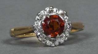 An 18 ct gold fire opal and diamond ring Of flowerhead form.