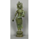 A large Indian patinated bronze model of a female deity Modelled standing, wearing a headdress.