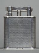 A silver plated Dunhill table lighter Of typical engine turned form,