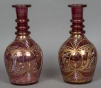 A pair of Continental cranberry glass gilt and enamel decorated oversized decanters 35.5 cm high.