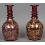 A pair of Continental cranberry glass gilt and enamel decorated oversized decanters 35.5 cm high.