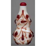 A Chinese Peking glass red overlay snuff bottle Of double gourd form with overall scrolling foliate