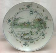 A large 18th century Chinese porcelain dish Centrally painted with figures in a garden,