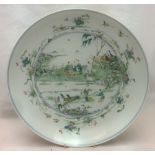 A large 18th century Chinese porcelain dish Centrally painted with figures in a garden,