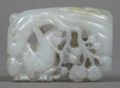 A Chinese carved pale jade pendant Worked with a bird amongst prunus blossom. 4.5 cm long.