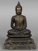 An antique gilt bronze model of Buddha Typically modelled seated in the lotus position wearing a