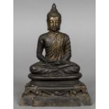 An antique gilt bronze model of Buddha Typically modelled seated in the lotus position wearing a