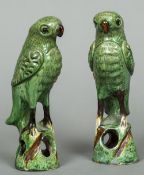 A pair of Chinese pottery models of parrots Each formed standing on a pierced base.