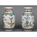 A pair of late 19th/early 20th century brightly painted Chinese porcelain vases Decorated with