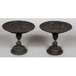 A pair of 19th century patinated bronze tazzas Each bowl cast with a female mask roundel,
