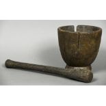 An antique turned wood pestle and mortar 50 cm long; 23 cm high respectively.