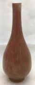 A Chinese flambe porcelain vase Of slender form, with allover mottled red glaze. 17.5 cm high.