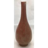 A Chinese flambe porcelain vase Of slender form, with allover mottled red glaze. 17.5 cm high.