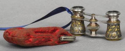 A pair of late 19th/early 20th century opera glasses Each barrel decorated with scrolling foliage.