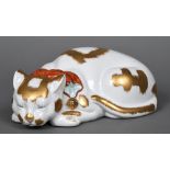 A large Japanese Kutani porcelain model of a recumbent cat Naturalistically modelled wearing a